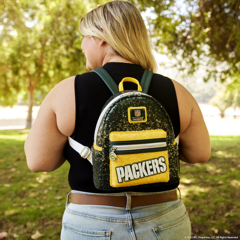 Image of woman facing away from camera wearing the NFL Green Bay Packers Sequin Mini Backpack 